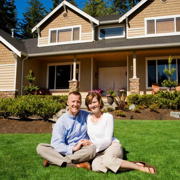 happy couple in front of hom